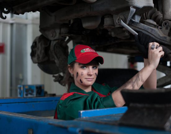 Woman working on car