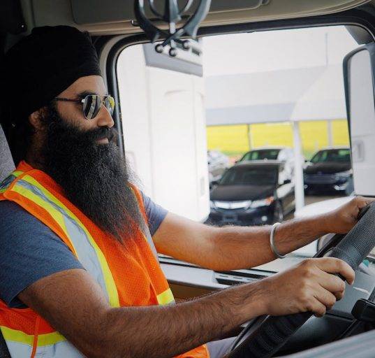 Truck Driver Seated in Cab of truck