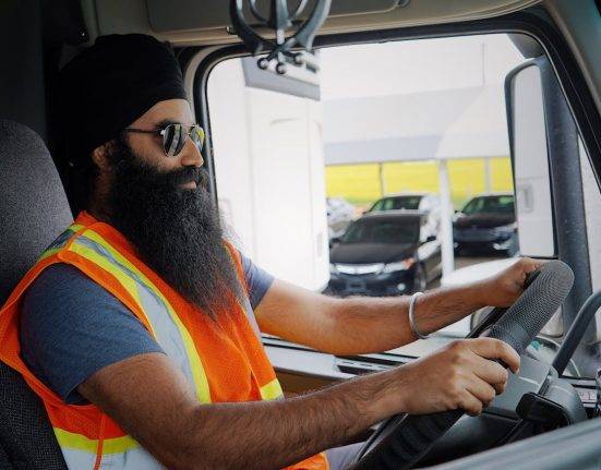 Truck Driver Seated in Cab of truck