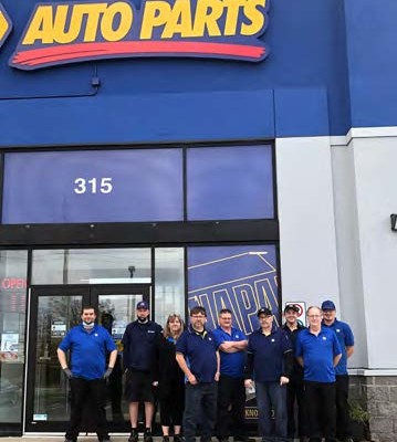 Napa employees standing in front of Napa Auto Parts